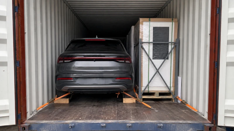 Electric vehicle and EV charger securely packed and lashed inside the same shipping container